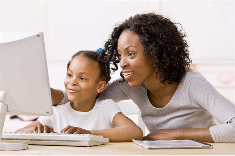 Black woman and child in front of computer