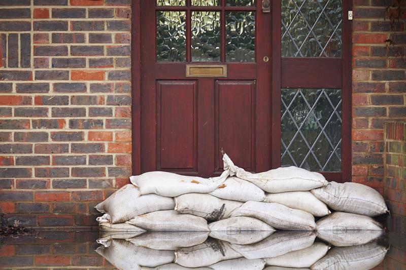 sandbags outside front door of flooded house