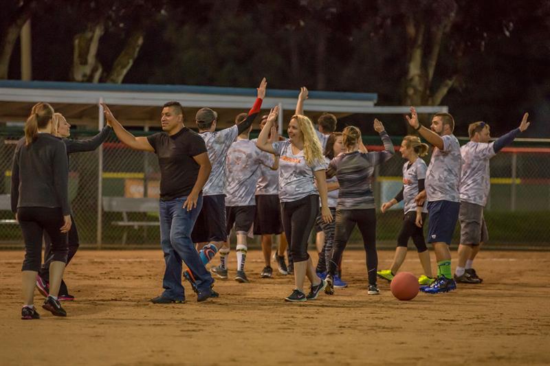 Kickball players high-five each other after a game