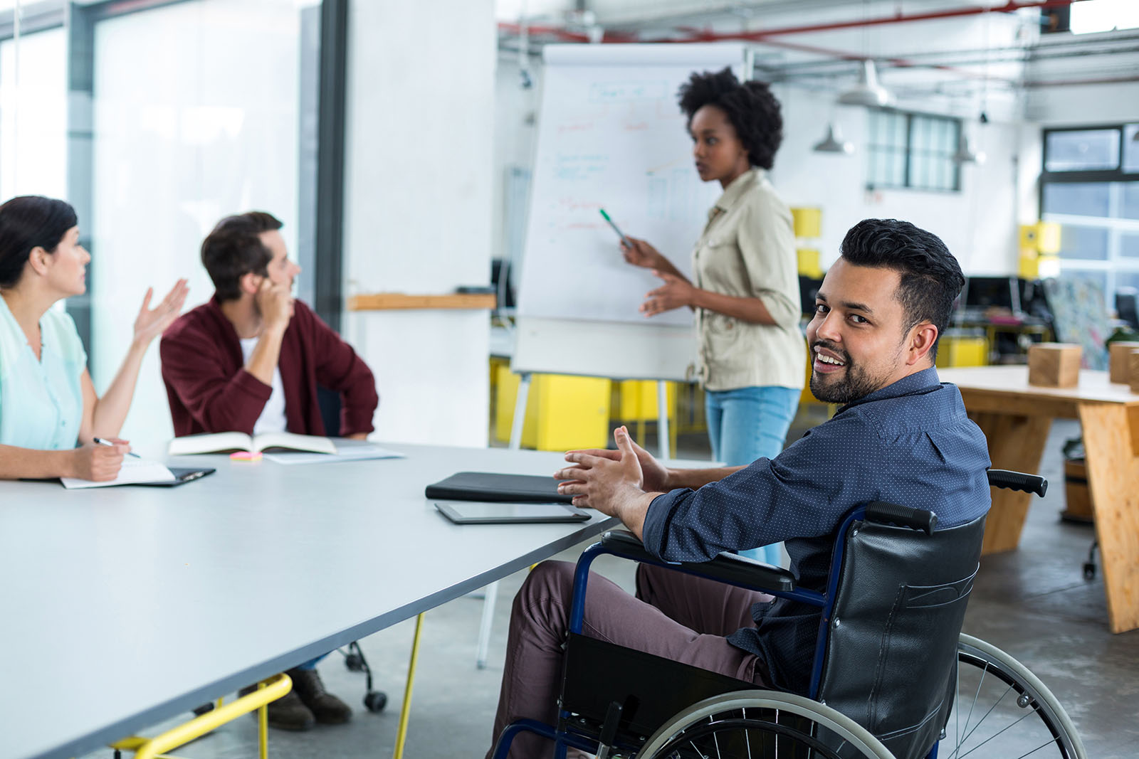 disabled business executive in wheelchair at a meeting