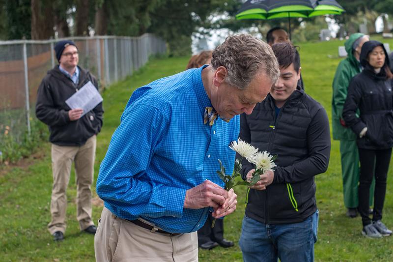 City Councilor Tom Andersen places flowers on the Chinese Shrine as part of the Qingming Festival blessing ceremony