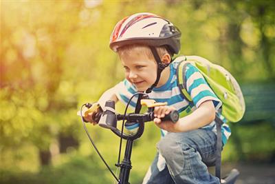 boy riding bicycle outdoors