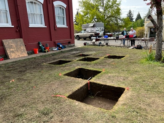 A field of test pits indicates a public archaeology dig in Salem.