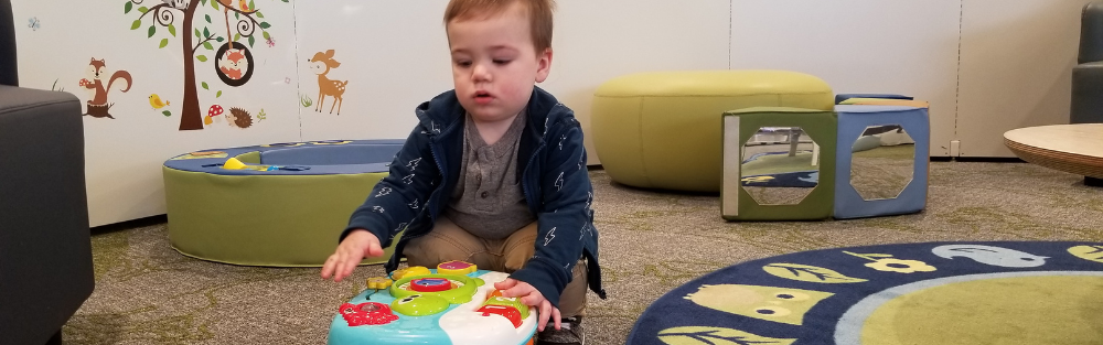 Toddler plays with toys in the Children's Corner