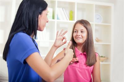 women child learning sign language