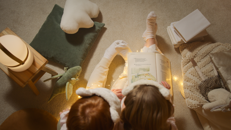 Children in pajamas reading books