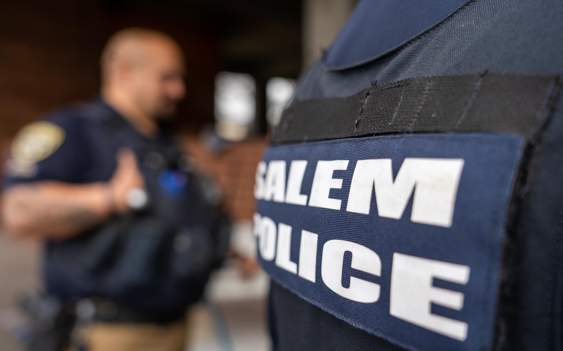 Two officers with a Salem Police badge