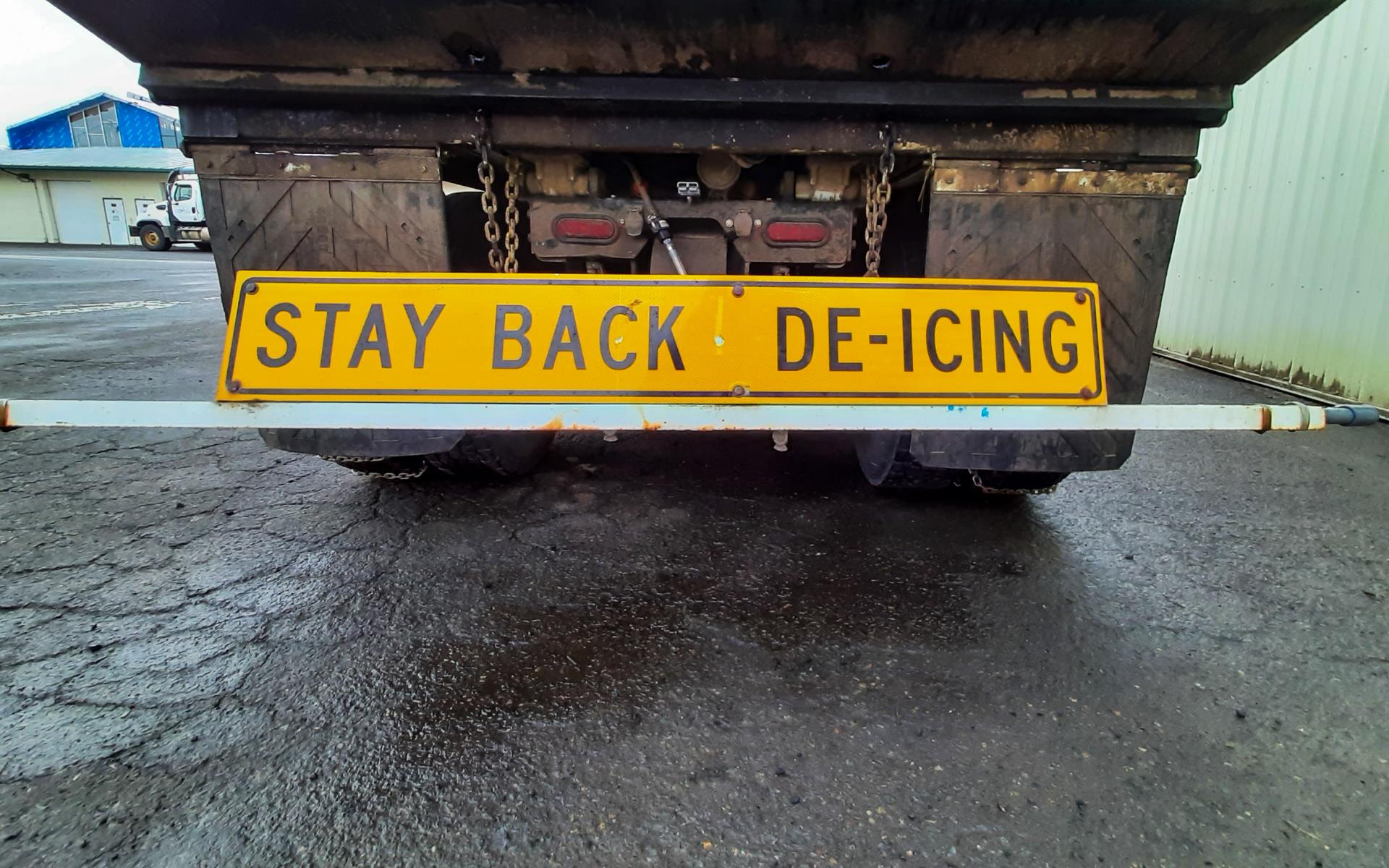 deicer sign on back of truck