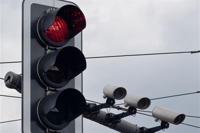 traffic light on red with traffic cameras on pole
