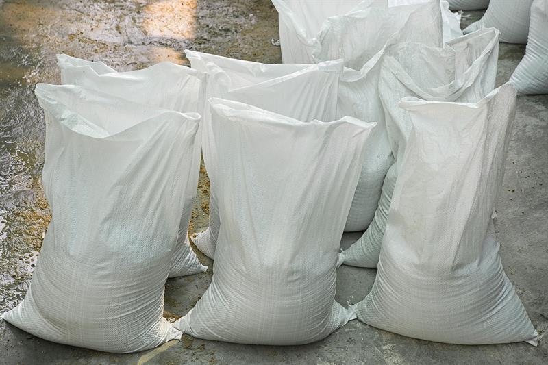 white sand bags standing upright