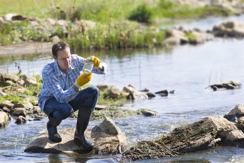 man testing quality of natural water